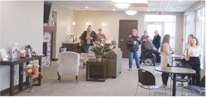 NEW FACILITIES - Visitors enjoy refreshments in the large reception area at the new Levander Funeral Home building. More photos on page 14.