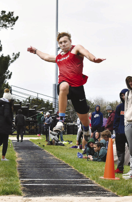 Cardinal senior James Fogleman takes flight on his way to a sixth place finish in the Northwest Dave Gee Invite triple jump. (Photo, Nolan Vandenberg, Boone Central Schools)